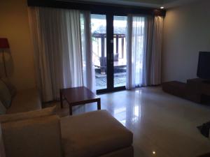 a living room with a couch and a table at Seminyak Apartment by LBV in Seminyak