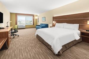 a hotel room with a large bed and a desk at Holiday Inn Express Corning by IHG in Corning +19 photos