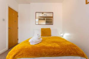 a bed with a white cat sitting on top of it at Midas Lodge in Newcastle upon Tyne
