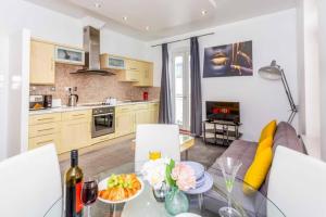 a kitchen and living room with a glass table with food on it at Midas Lodge in Newcastle upon Tyne +24 photos