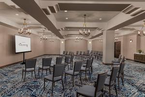a conference room with chairs and a projection screen at Kimpton Canary Hotel by IHG in Santa Barbara