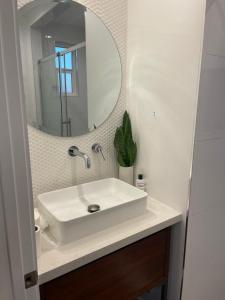 a bathroom with a white sink and a mirror at Inglewood Forum and Sofi park and walk private room in Inglewood +5 photos