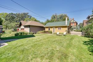 a house with a large yard with a green lawn at Studio in Historic Cathedral Hill Neighborhood! in Saint Paul