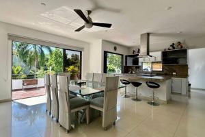 a kitchen with a dining table and a ceiling fan at Villa in Guaduala