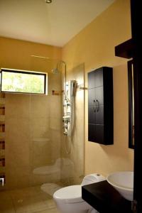 a bathroom with a sink and a toilet and a shower at Villa in Guaduala