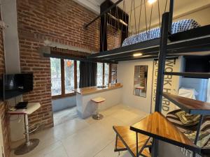 a room with a brick wall and a loft at Monica’s Apartments in Canning