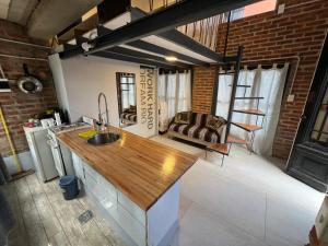 a kitchen with a counter top and a living room at Monica’s Apartments in Canning