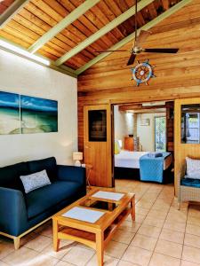 a living room with a couch and a table at Beachside Cottage - A Private Peaceful Hidden Gem 50m to Beach in Nelly Bay