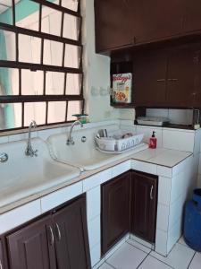 a kitchen counter with a sink and a window at Hostal Primaveras nest habitación 3 in Santa Ana +24 photos