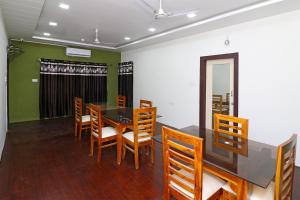 a dining room with a table and chairs at Hotel O Krishna Hotel and Restaurant in Raipur