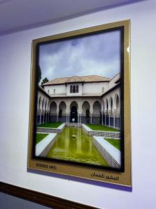 a picture of a building with a pool of water at Appartements équipés luxe in Mansoûra