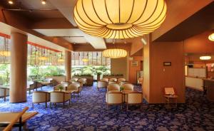 a waiting room with chairs and tables and a large chandelier at Hotel Koyo in Kaminoyama +27 photos