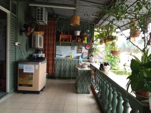 a kitchen with a dog sitting on a balcony at Marco Polo Guest House in Kuching