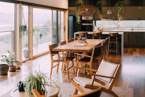 a kitchen with a large wooden table and chairs at The Good House in Kiewa