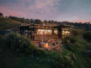 a large house sitting on top of a hill at The Good House in Kiewa