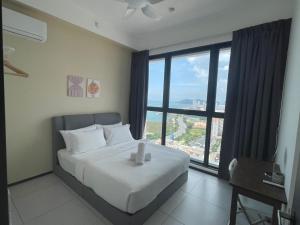 a bedroom with a large bed and a large window at Urban Suite Condominium By Blue Sky Holidays in Jelutong +105 photos
