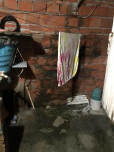 a brick wall with a towel hanging on a wall at TubacityHouse in Salvador