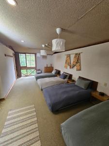 Postel nebo postele na pokoji v ubytování Yamadasan Ski Lodge - Madarao
