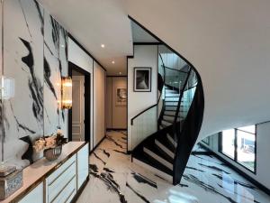 a staircase in a house with a glass wall at Luxury Pool Villa 5BR 12pax with Private Lift in Ekkamai in Bangkok +49 photos