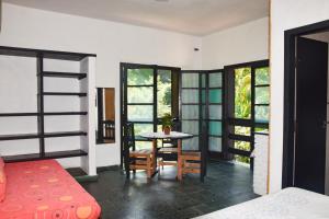 a room with a bed and a table and chairs at Chalés Suítes Ubatuba Paradise Toninhas in Ubatuba +119 photos