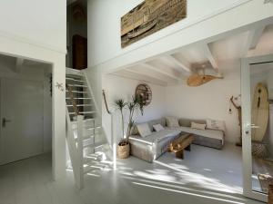a white living room with a bed and a staircase at Villa rénovée avec accès plage, clim, WiFi, parking - FR-1-413-248 in Capbreton