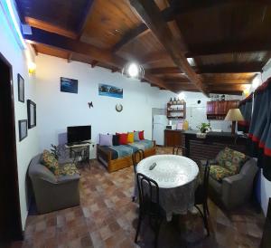 a living room with a table and chairs and a kitchen at Mar del Plata in Mar del Plata