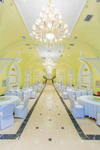a large banquet hall with white tables and white chairs at Changchun Garden Hotel in Changchun +224 photos