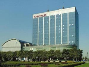 a large building with a sign on the side of it at Beijing Jinjiang Fuyuan Hotel in Beijing