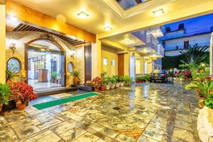 Un gran vestíbulo con muchas plantas. en Da Yatra Courtyard Hotel & Resort, en Pokhara