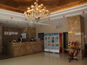 a hotel lobby with a cash counter and a chandelier at GreenTree Inn Yancheng Economic Development Zone Management Committee Express Hotel in Yancheng