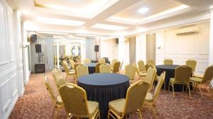 a conference room with tables and chairs and a podium at Hotel Pondok Asri Boyolali in Boyolali