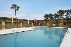 a large swimming pool in front of a hotel at Days Inn by Wyndham Brunswick/St. Simons Area in Glynn Heights