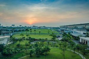 a view of a city with a park with palm trees at Luxury Airport Hotel & Spa in Phu Lo Dong