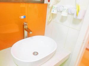 a bathroom with a white toilet and a sink at 7 Days Premium JiNan Jingshi Road Qilu Children's Hospital Exhibition Center in Jinan