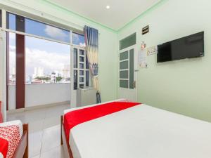 a bedroom with a bed and a large window at OYO 898 Phuong Thao Hotel in Nha Trang