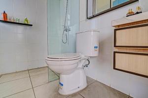 a bathroom with a white toilet in a room at OYO Life 92719 Rolling Hills Residence Karawang in Badami +26 photos