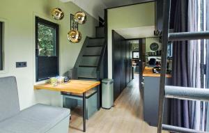 a tiny house with a desk and a staircase at Cozy Apartment In Lieren With Wifi in Loenen