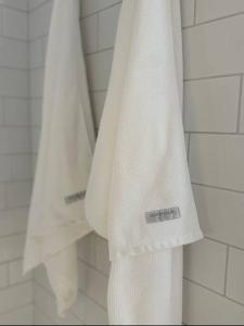 a white towel is hanging in a bathroom at The Warra House in Dubbo