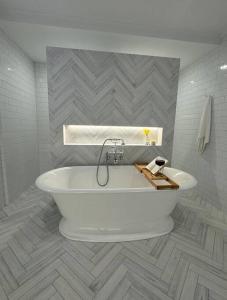 a white bath tub in a bathroom with tiles at The Warra House in Dubbo +58 photos