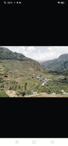 a view of a valley with houses on a mountain at Batad Village Homestay & Restaurant in Banaue