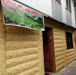 a building with a sign on the side of it at Batad Village Homestay & Restaurant in Banaue