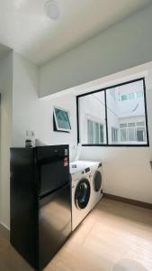 a laundry room with a washing machine and a window at Inara Homestay in Kuala Lumpur +6 photos