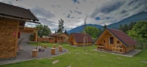 a group of small wooden houses in a yard at Radlerstation-Sandhof in Berg im Drautal