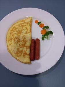 a white plate with two hot dogs and a tortilla at Blue Sands Beach Resort in Pasikuda +8 photos