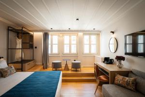 a bedroom with a bed and a table and chairs at Navria by Aetoma in Nafplio