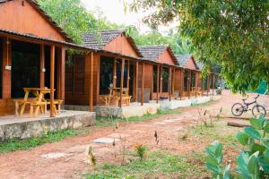 a row of wooden houses in a row at Wonderland Hostel in Anjuna