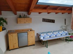 a patio with a bench and a table with bottles of water at Wohlfühlwohnung in Rappottenstein