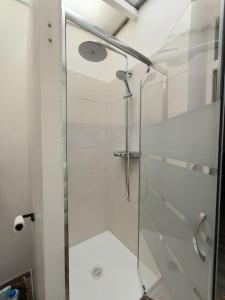 a shower with a glass door in a bathroom at Le Cosy du Centre - Proche plage et Port in Grand-Fort-Philippe