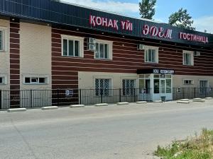 a building with a sign on the side of it at Эдем in Taraz