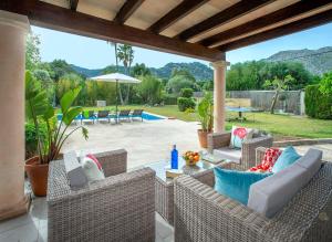 a patio with wicker chairs and a table at Can Menonge by Vintage Travel in Pollença